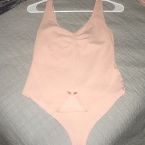 Pink body suit